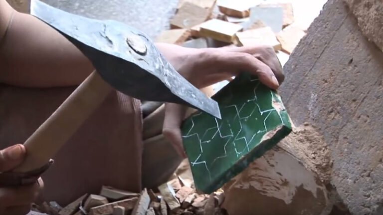 Artisan hand-cutting Moroccan zellige tiles